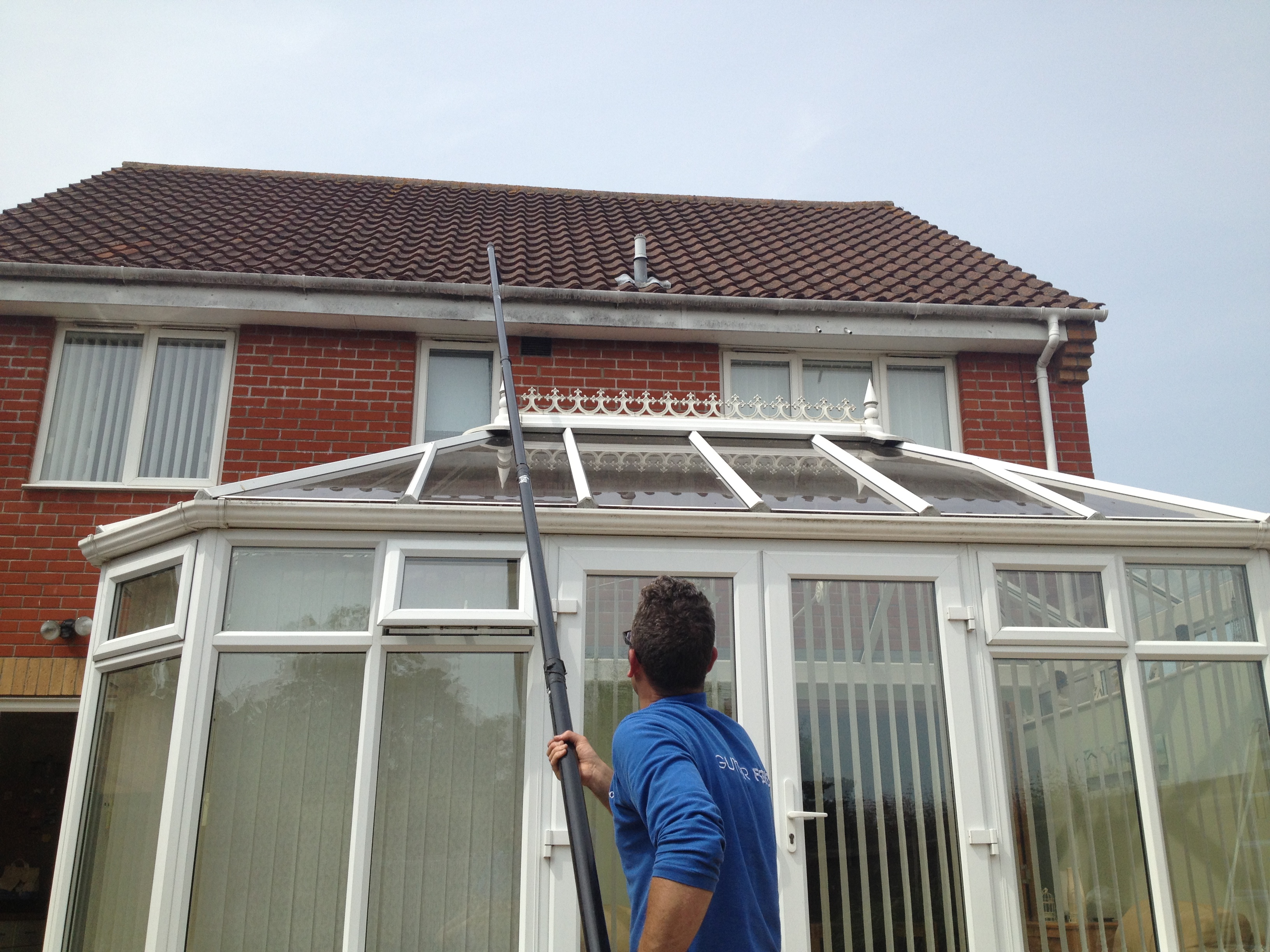 Gutter cleaning Norwich - house with conservatory